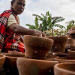 Perajin menata hasil kerajinan gerabahnya yang baru selesai dibakar di Kelurahan Duyu, Palu, Sulawesi Tengah, Minggu (12/12/2021). (bmzIMAGES/Basri Marzuki)